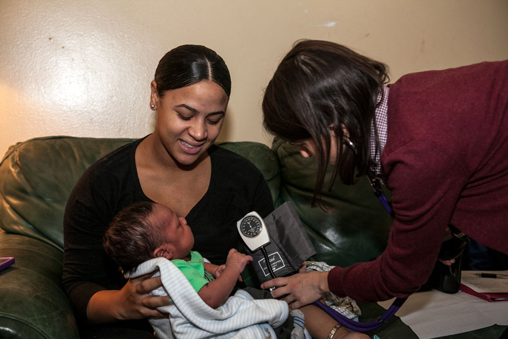 Brigida checks Brianna's blood pressure.